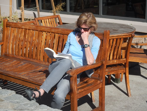 Squaw reading on the deck